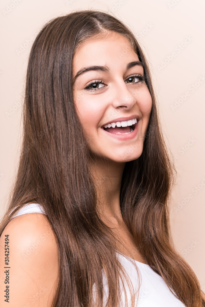 Young cute caucasian woman against a beige background Young cute caucasian woman against a beige background