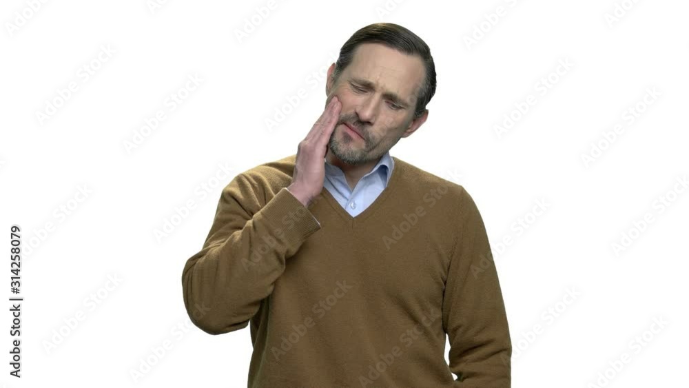Sad man having toothache and touching cheek. Handsome mature man suffering from strong tooth pain over white background. Sad man having toothache and touching cheek. Handsome mature man suffering from strong tooth pain over white background.