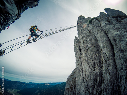 Via ferrata Intersport Klettersteig - climbing up a long ladder photo