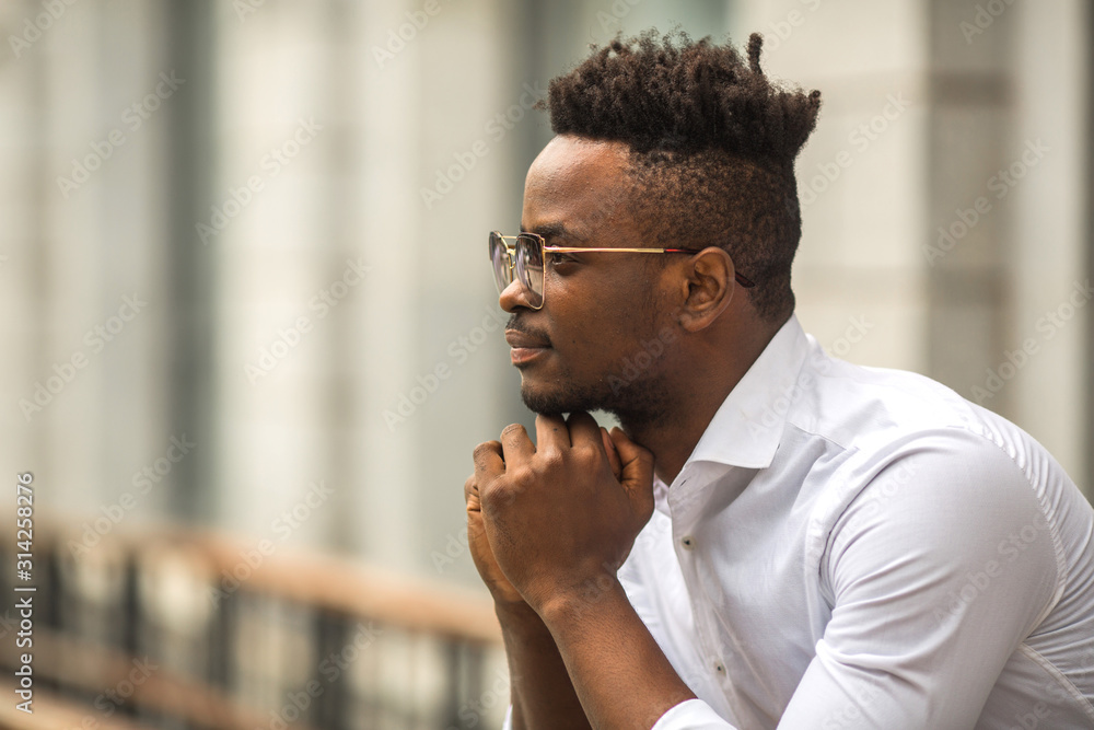 Obraz premium handsome young african man in a white shirt