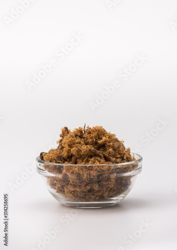 Domestic salty fried Pork greaves, duvan cvarci, in a Glass Bowl on a white background photo