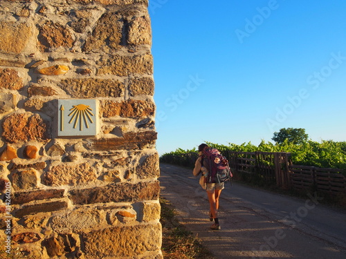 Pilgrim with yellow scallop shell mark, Camino de Santiago, Way of St. James, Journey from Ponferrada to Villafranca del Bierzo, French way, Spain