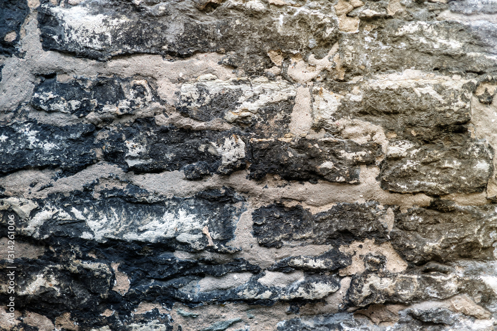 old fortress black wall texture. the texture of the stone masonry of the black bricks old fortress black wall texture. the texture of the stone masonry of the black bricks