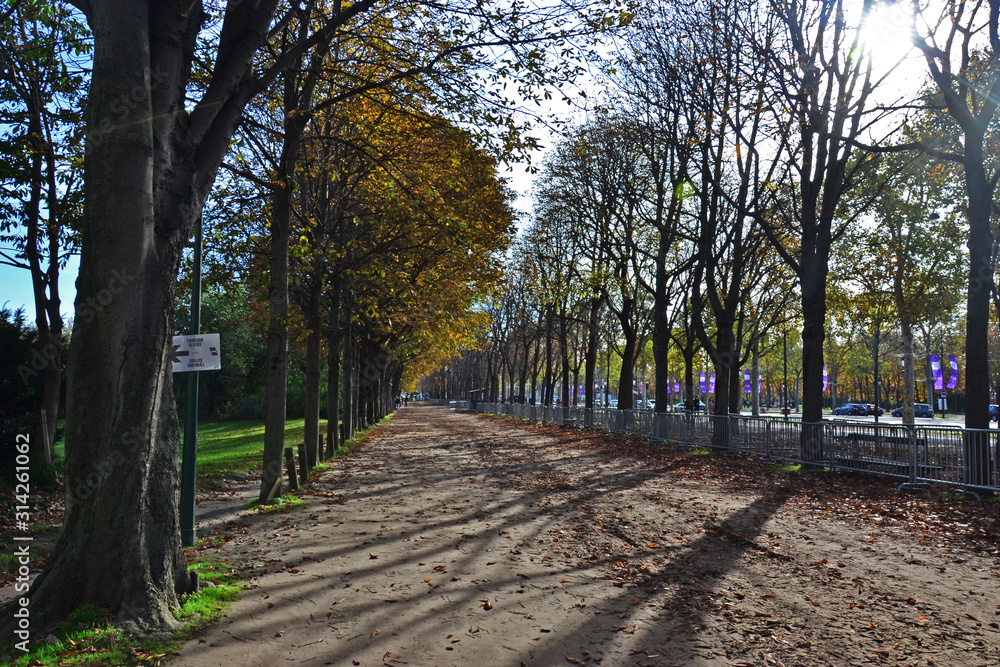 Paris, France - October 26th 2019 : Pavement down the Champs-Elysees avenue, which looks like a park. Paris, France - October 26th 2019 : Pavement down the Champs-Elysees avenue, which looks like a park.