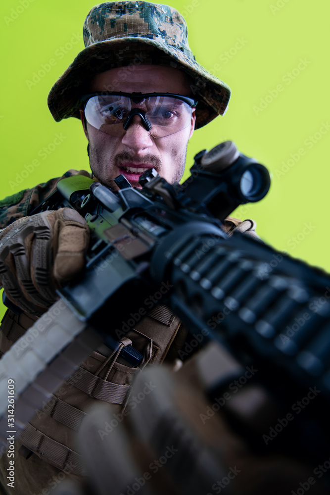 soldier in action aiming laseer sight optics green background