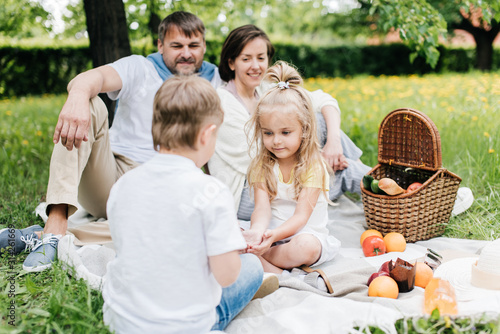 Kids communicating with each other at family picnic.