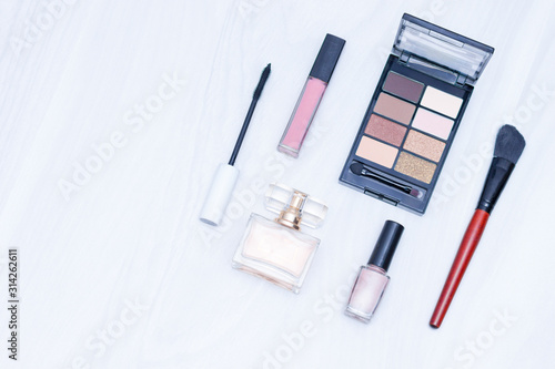 Set of cosmetics for make up (brushes, shadows). Make up nude essentials on white wooden background. Flat lay, copy space, blogging concept.