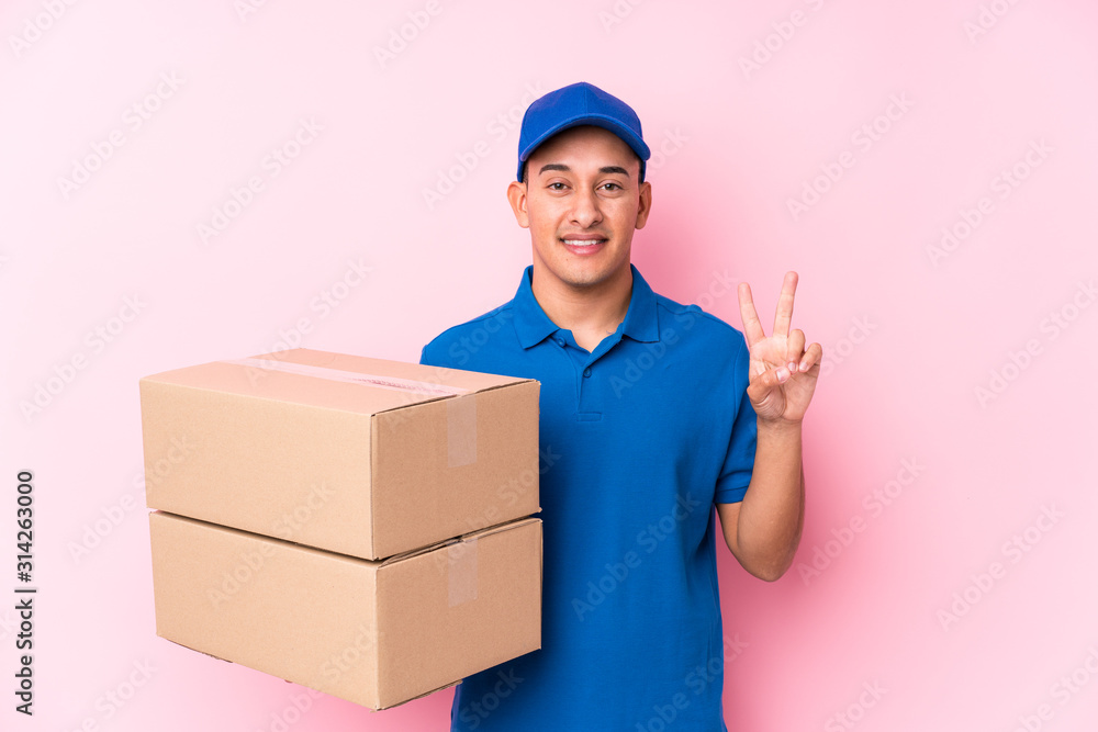 Young latin delivery man isolated showing number two with fingers. Young latin delivery man isolated showing number two with fingers.