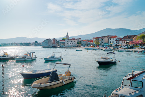 Kastel coast in Dalmatia,Croatia. A famous tourist destination on the Adriatic sea. Fishing boats moored in old town harbor. © luengo_ua