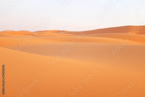 Bright orange desert sand dunes in the Arabian Desert in Riyadh, Saudi Arabia
