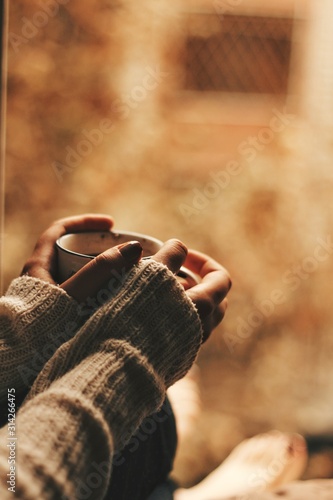 girl holding a cup of tea/coffee