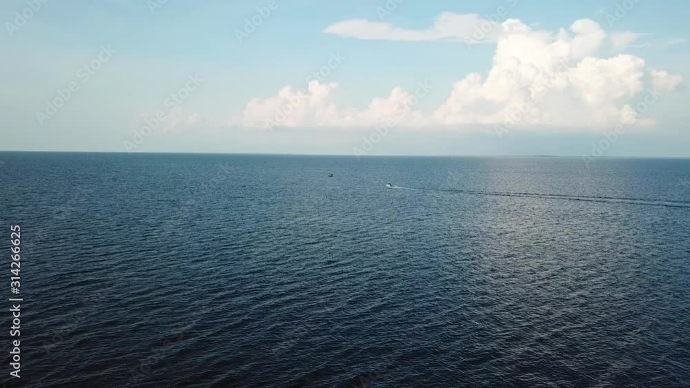 Serene Seascape in Chesapeake Bay, Maryland. Boat Sailing Under Summer Sky, Drone Aerial View Serene Seascape in Chesapeake Bay, Maryland. Boat Sailing Under Summer Sky, Drone Aerial View