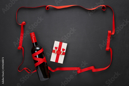 Valentine's day, Frame of red ribbon with wine and a gift box. wedding, engagement. Background photo. 