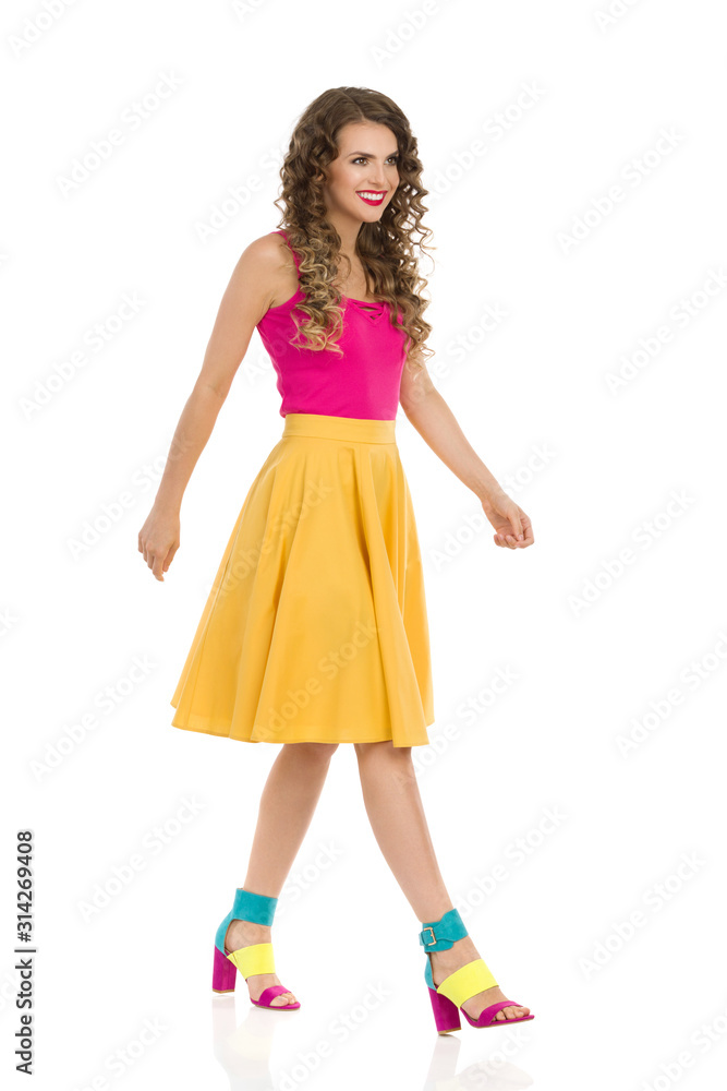 Walking Young Woman Is In Colorful Clothes And High Heels