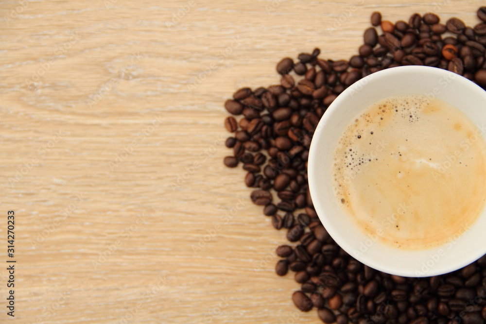 a cup with coffee and coffee beans a cup with coffee and coffee beans
