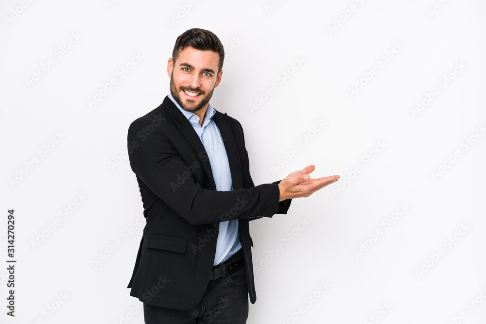 Young caucasian business man against a white background isolated holding a copy space on a palm. Young caucasian business man against a white background isolated holding a copy space on a palm.