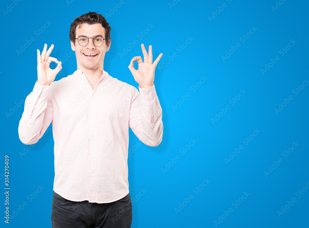 Naklejka premium Surprised young man with a gesture of approval