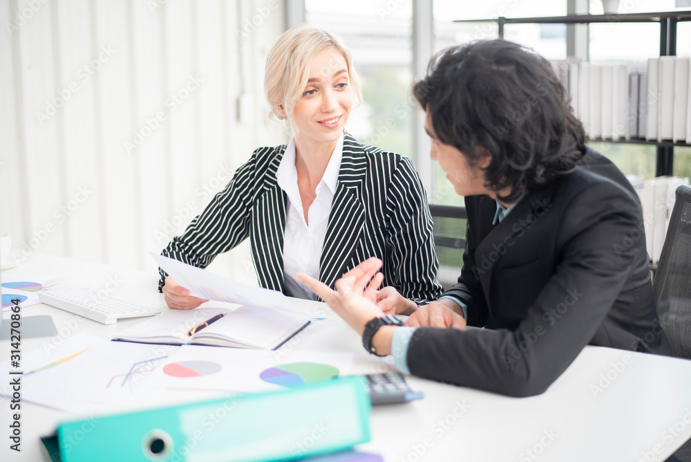Business people are analyzing financial report Business people are analyzing financial report