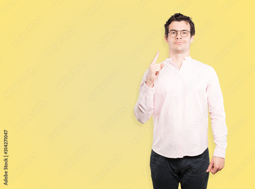 Friendly young man doing a gesture of confidence Friendly young man doing a gesture of confidence