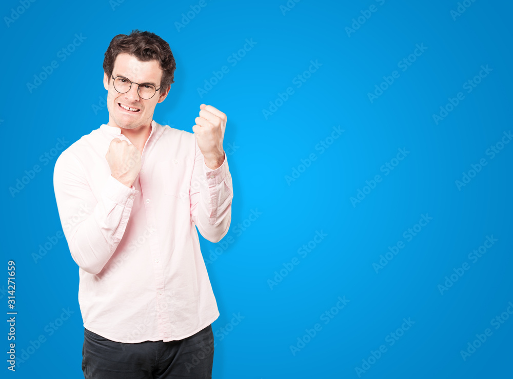 Competitive young man making a gesture of celebration Competitive young man making a gesture of celebration