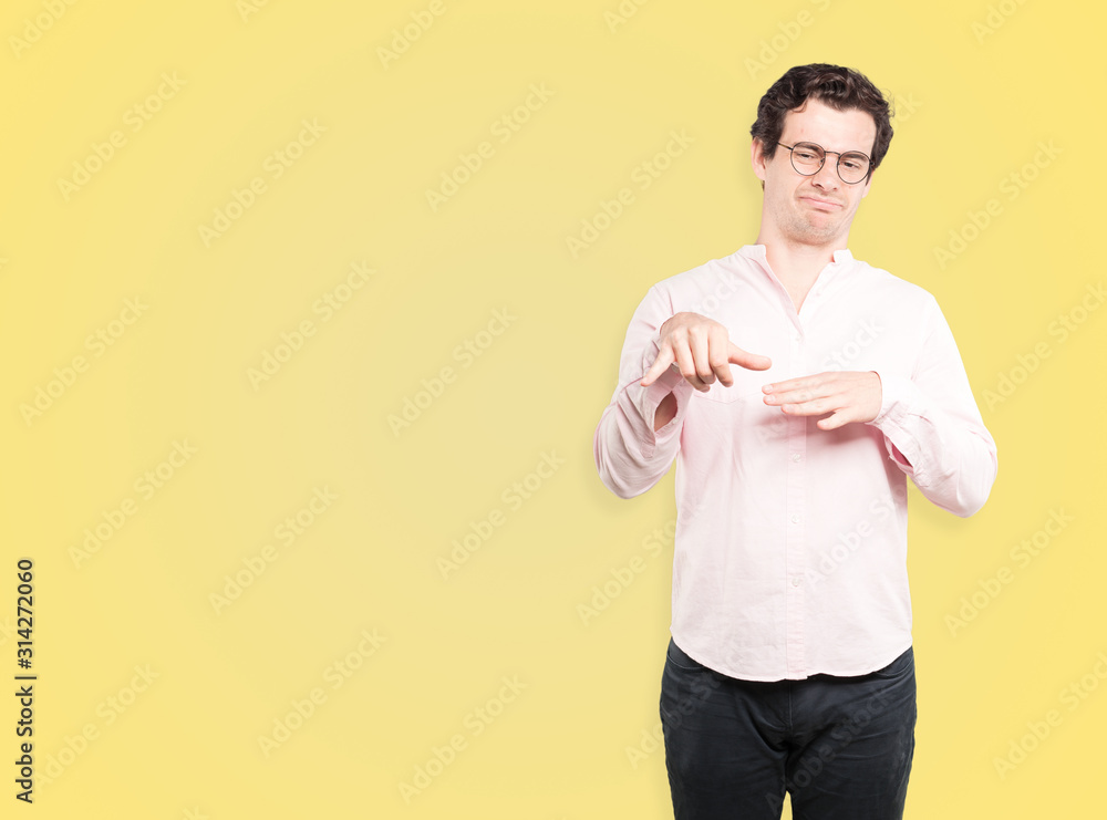 Hesitant young man making a gesture of calling with the hand Hesitant young man making a gesture of calling with the hand