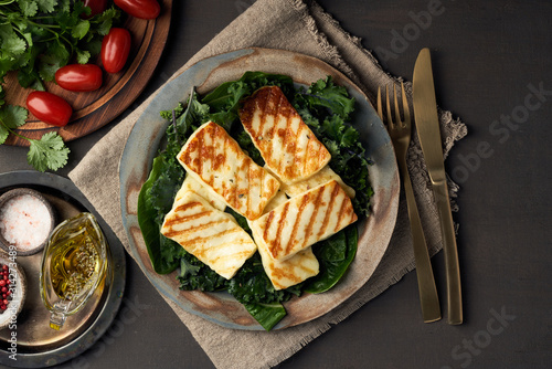 Cyprus fried halloumi cheese with healthy green salad. Lchf, pegan, fodmap, paleo, scd, keto diet. photo