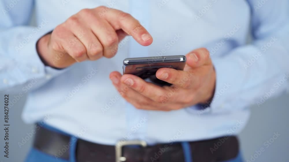 Formally dressed man using smartphone for serfing on internet close-up Formally dressed man using smartphone for serfing on internet close-up