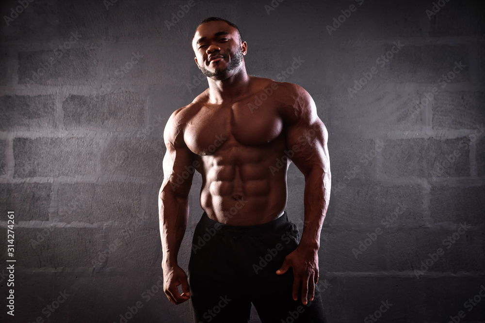 African american male athlete posing demonstrating muscular development
