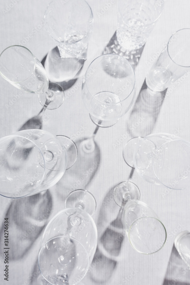 Top view of transparent glasses with shadow on grey cloth Top view of transparent glasses with shadow on grey cloth