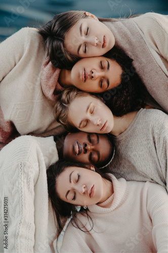 The portrait of multiracial group from five women.