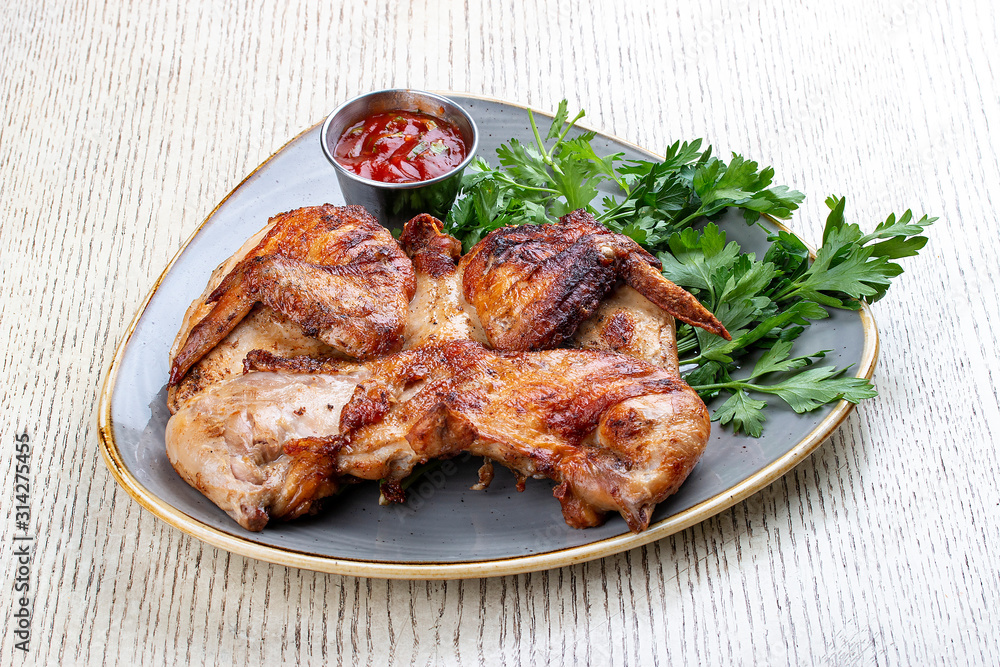 Tapaka chicken in a classic performance with.crispy garlic crust and Georgian sauce Tapaka chicken in a classic performance with.crispy garlic crust and Georgian sauce