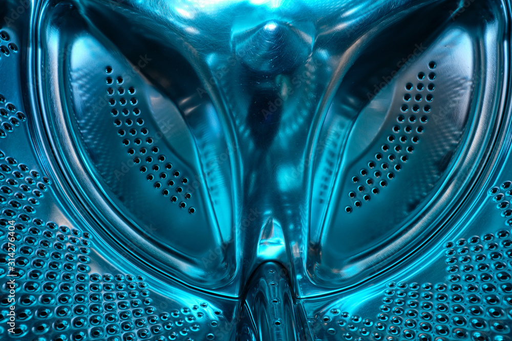 Futuristic look of a washing machine drum made of steel in blue light Futuristic look of a washing machine drum made of steel in blue light