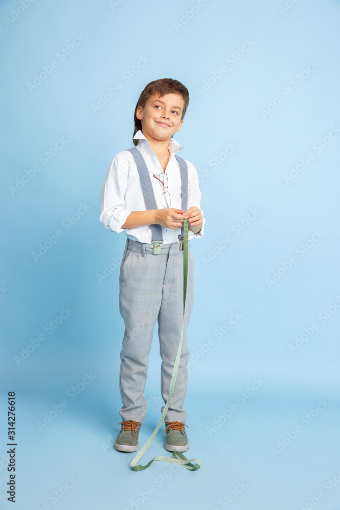 Future. Little boy dreaming about profession of seamstress. Childhood, planning, education and dream concept. Wants to become successful employee in fashion and style industry, atelier, makes clothes. Future. Little boy dreaming about profession of seamstress. Childhood, planning, education and dream concept. Wants to become successful employee in fashion and style industry, atelier, makes clothes.