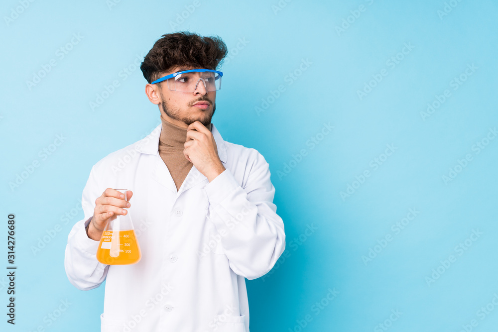 Young arab scientific man isolated looking sideways with doubtful and skeptical expression. Young arab scientific man isolated looking sideways with doubtful and skeptical expression.
