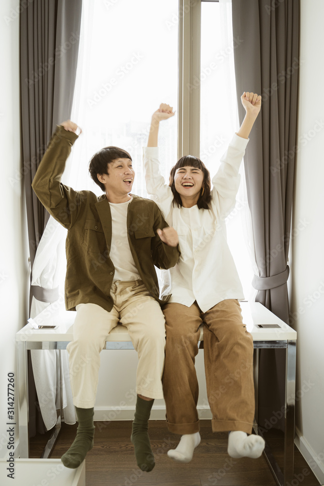 Young asian couple dancing together at home with happy. Young asian couple dancing together at home with happy.