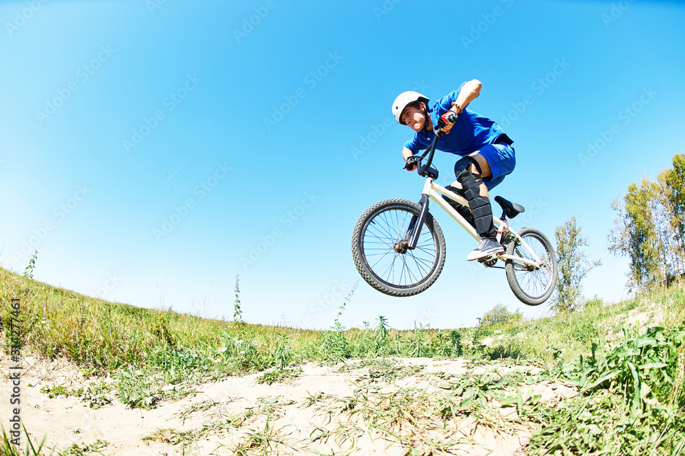 cyclist riding jumping with bicycle cross-country