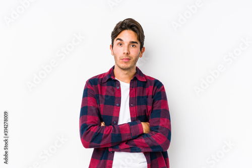 Young caucasian man posing in a pink background isolated unhappy looking in camera with sarcastic expression.