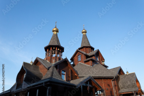 Against the blue sky, a wooden church, built in the old style.