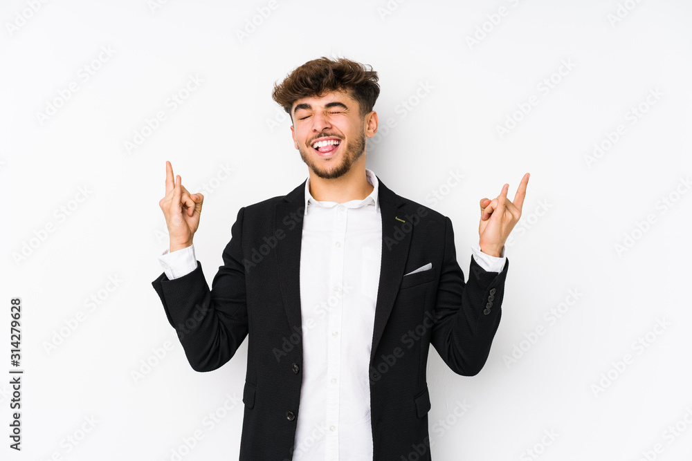 Young arabian business man isolated showing rock gesture with fingers Young arabian business man isolated showing rock gesture with fingers