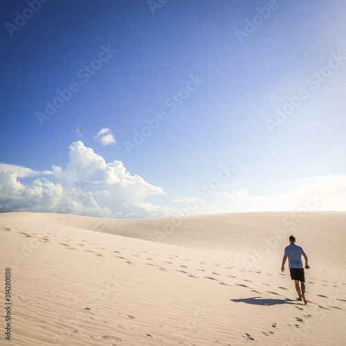 A solitary man making his way through the hot sun and sand dunes of Maranhao  Brazil.