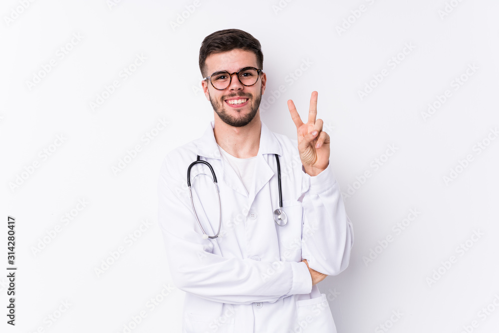 Young caucasian doctor man isolated showing number two with fingers. Young caucasian doctor man isolated showing number two with fingers.