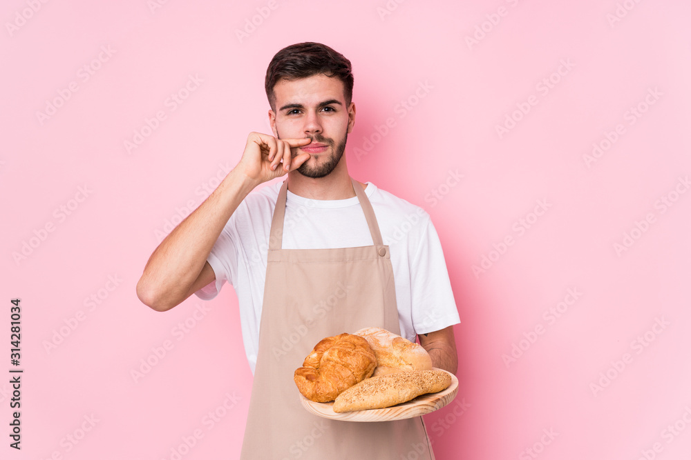 Young caucasian baker man isolated with fingers on lips keeping a secret. Young caucasian baker man isolated with fingers on lips keeping a secret.