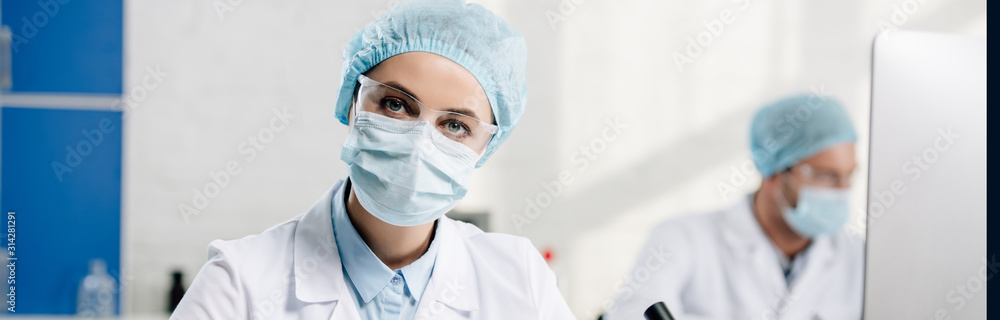 panoramic shot of genetic consultant looking at camera in lab panoramic shot of genetic consultant looking at camera in lab
