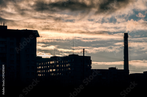 night cityscape with sunset and sky with clouds