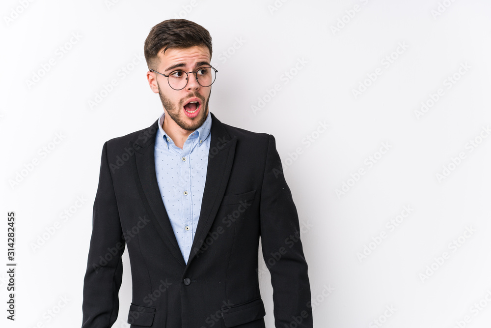 Young caucasian business man posing in a white background isolated Young caucasian business man being shocked because of something she has seen. Young caucasian business man posing in a white background isolated Young caucasian business man being shocked because of something she has seen.
