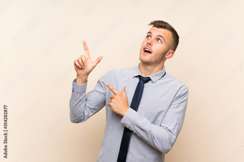 Young blonde businessman over isolated background pointing with the index finger a great idea Young blonde businessman over isolated background pointing with the index finger a great idea
