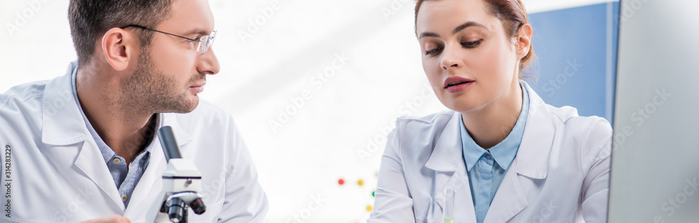 Fototapeta premium panoramic shot of molecular nutritionists talking in lab