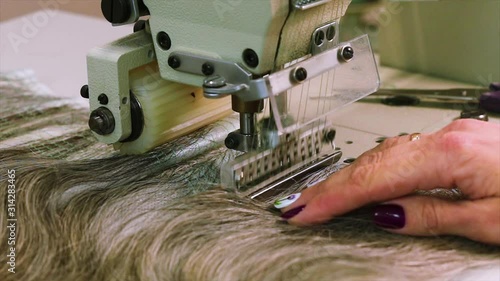 Wig manufacturing process, woman collects a wig. Wig assembly close-up photo