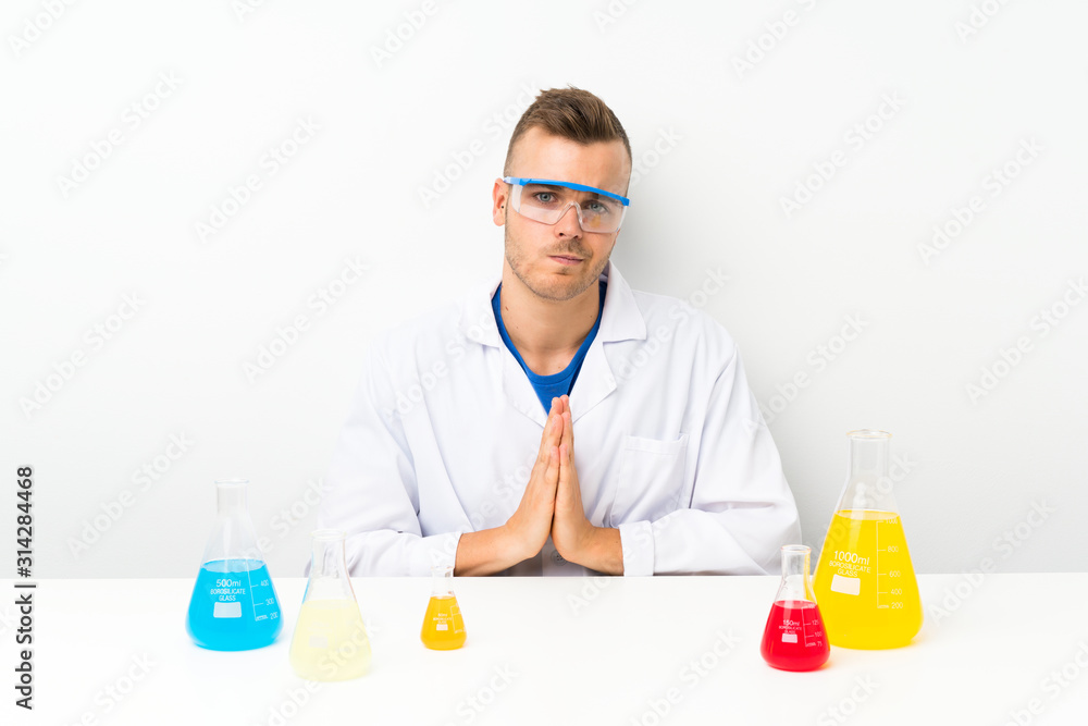 Young scientific with lots of laboratory flask pleading Young scientific with lots of laboratory flask pleading