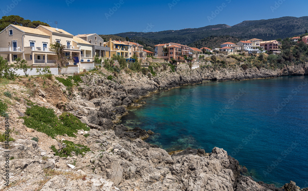 Wonderful summer seascape of Ionian Sea. Wonderful  place for holiday. Amazing Greece. Picturesque colorful village Assos in Kefalonia. Turquoise colored bay in Mediterranean sea. Amazing postcard